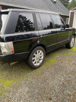 2006 Land Rover Range Rover Sport with 100,000 miles, featuring a black exterior and modern design.