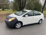 2005 Toyota Prius parked on the street, showcasing its sleek design and good condition.