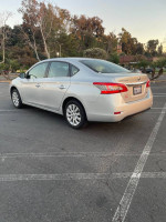 2014 Nissan Sentra S FWD in a parking lot, well maintained, with 135,000 mileage and clean interior and exterior.