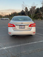 Rear view of a well-maintained 2014 Nissan Sentra SV parked in a lot, showcasing its clean exterior and license plate.