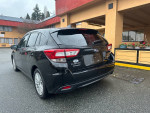 2018 Subaru Impreza 2.0i AWD parked outside, clean condition with all season tires and light tinted glass.