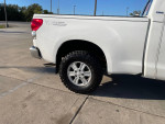 2007 Toyota Tundra SR5 4WD with new oversized tires and leveling kit parked on pavement