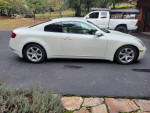 2006 Infiniti G35 Coupe in white, well-maintained and adult-owned with new tires, parked on a driveway.