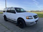 2003 Ford Expedition XLT FX4 4WD in white, showcasing smooth exterior and 9-seater capacity, available for sale.