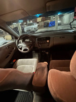 Interior view of a 1998 Honda Accord LX with clean seating and dashboard in a parking garage.