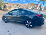 2014 Honda Civic EX Coupe in black, showcasing alloy wheels and sleek design, parked in a residential area.