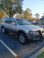 2001 Honda Passport EX RWD parked, needs jump start, offers good value at $2500, with visible exterior wear.