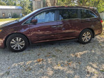 2016 Honda Odyssey SE minivan parked on gravel, well-maintained with no issues, ideal for family trips